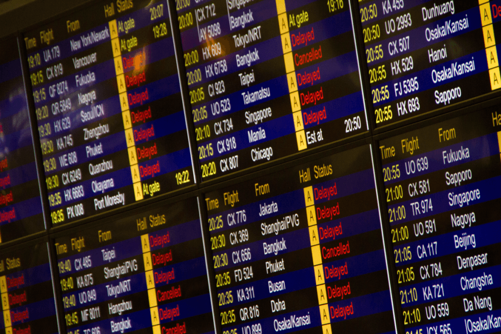 Airport departure board showing delayed and cancelled flights. Can you cancel a Virgin Atlantic flight in this situation?