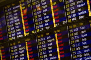 Airport departure board showing delayed and cancelled flights. Can you cancel a Virgin Atlantic flight in this situation?
