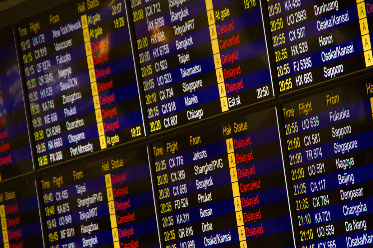 Airport departure board showing delayed and cancelled flights. Can you cancel a Virgin Atlantic flight in this situation?