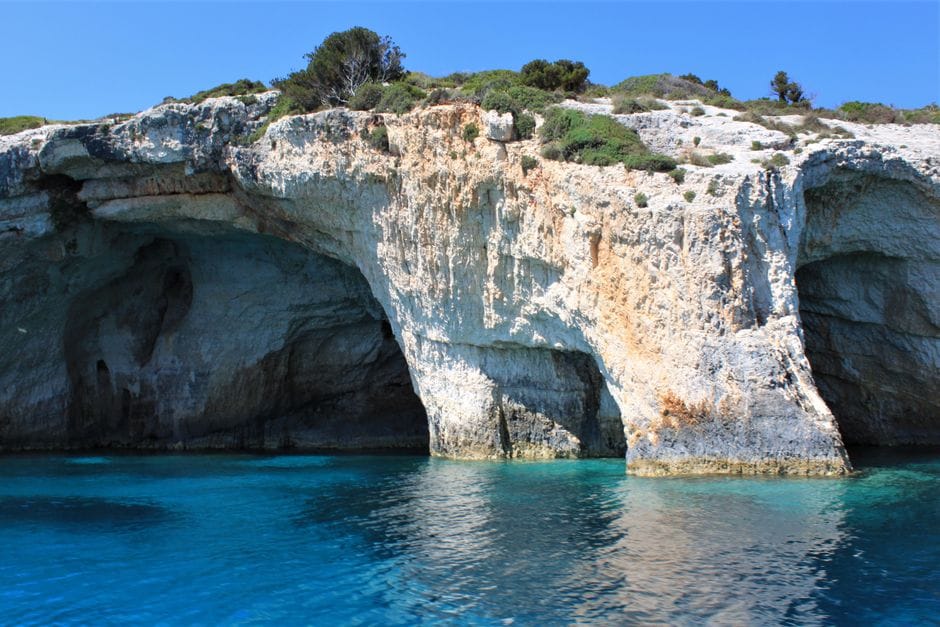 Zakynthos's Blue Caves, clear turquoise water inside pale rock formations only reachable by boat