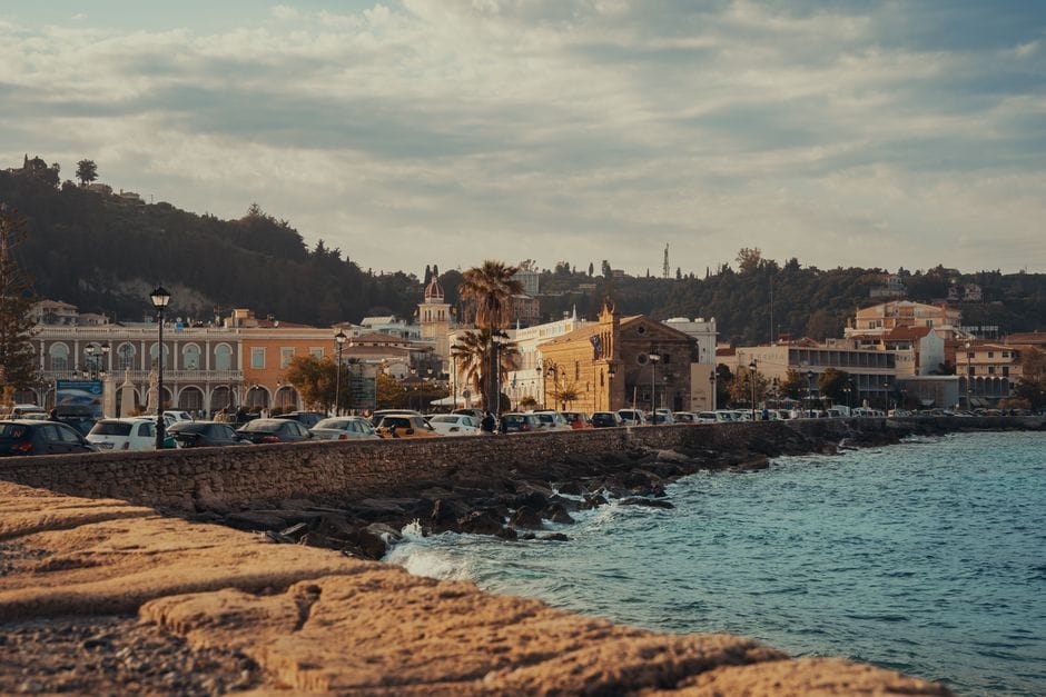 A coastal view of Zakynthos with historic architecture and a seaside promenade
