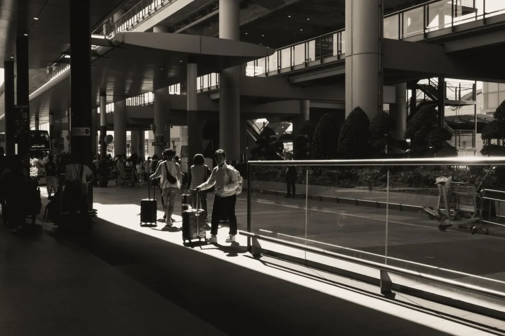 Booking an airport transfer in advance: travellers walking through the terminal to meet their pre-arranged ride