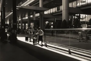 Booking an airport transfer in advance: travellers walking through the terminal to meet their pre-arranged ride