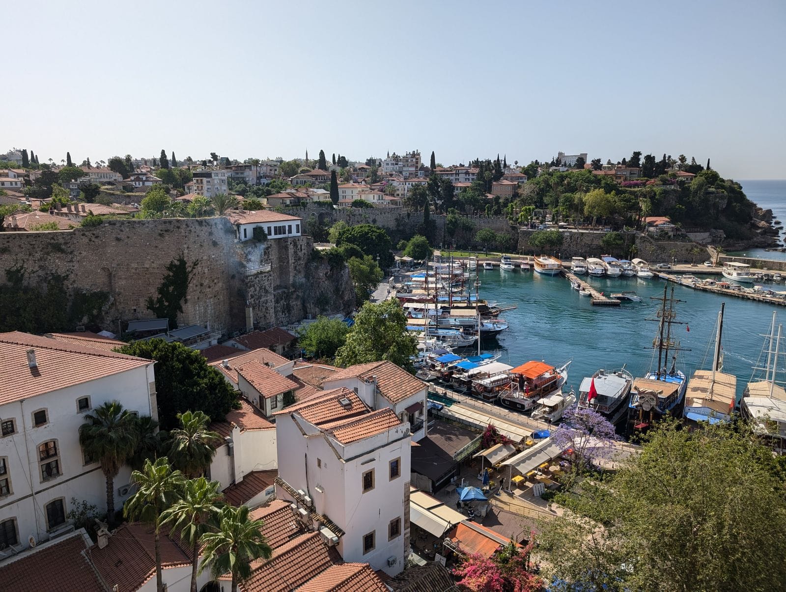 Aerial view of Kaleici harbour in Antalya, yachts and boats moored inside the old stone harbour walls