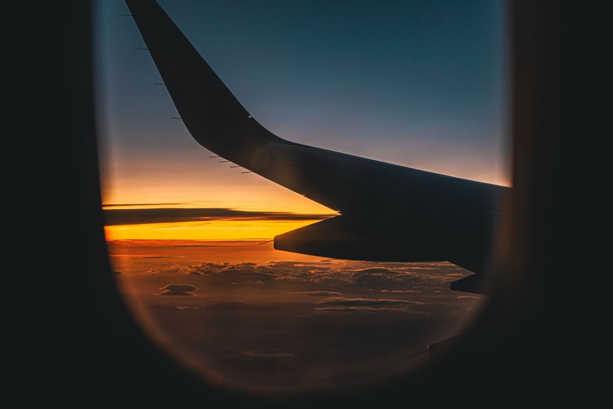 View of an aircraft wing against a sunset sky from the window seat