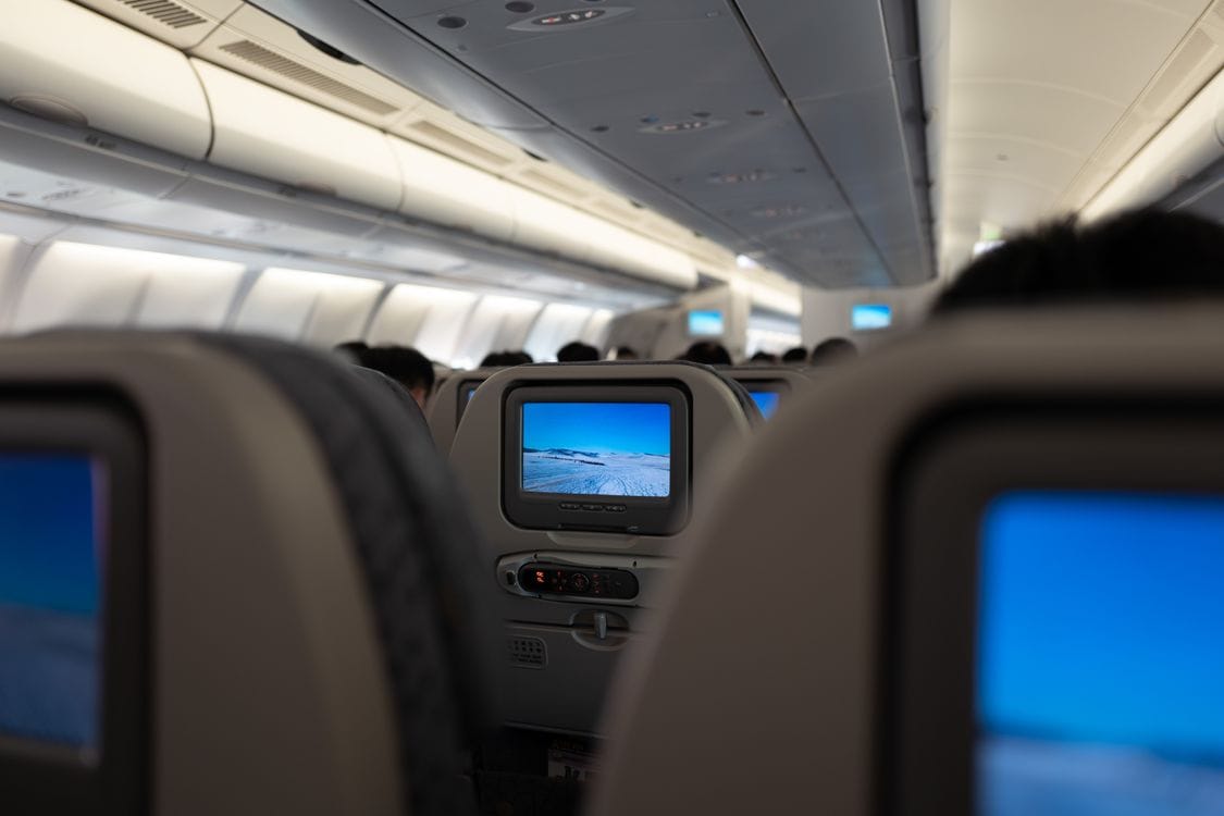 British Airways WiFi: rows of seatback screens lit up inside a cabin