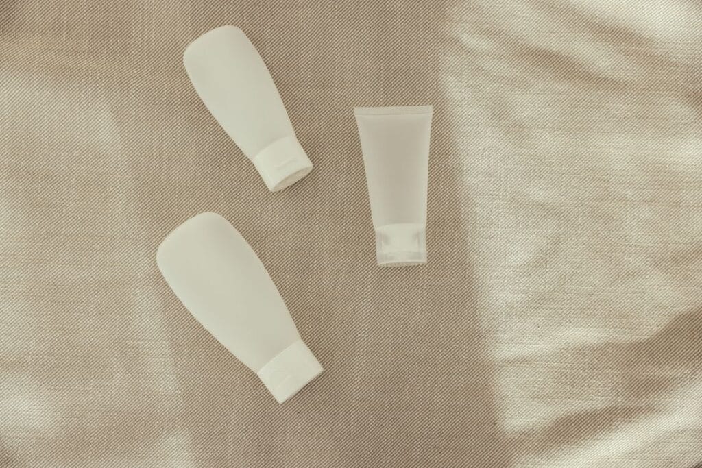 easyJet liquid rules: small white travel squeeze bottles laid out on a linen cloth