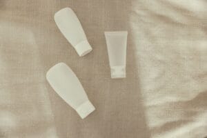 easyJet liquid rules: small white travel squeeze bottles laid out on a linen cloth