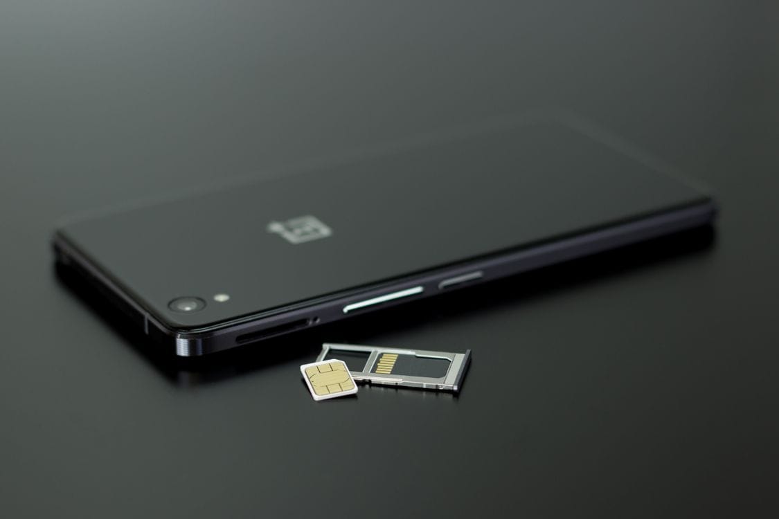 A close-up of a physical SIM card: an eSIM does the same job without the plastic or the swap