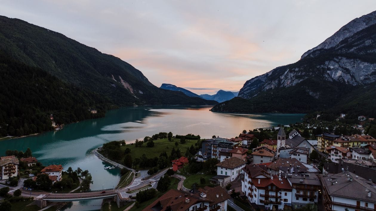 Sunset over Lake Molveno in Trentino, Italy, mountains reflected in still water