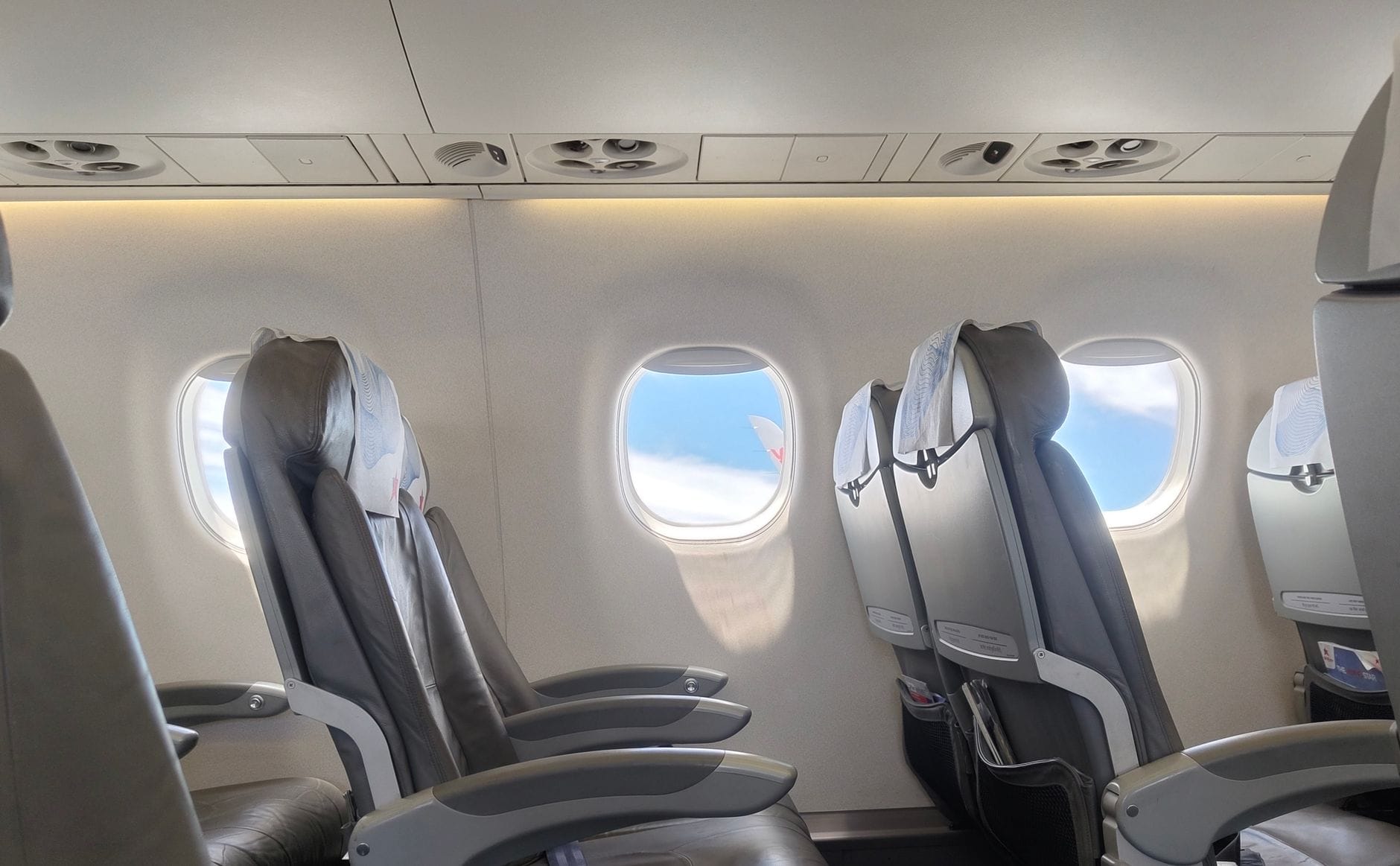 Empty Jet2 aircraft cabin with a window seat view of clouds