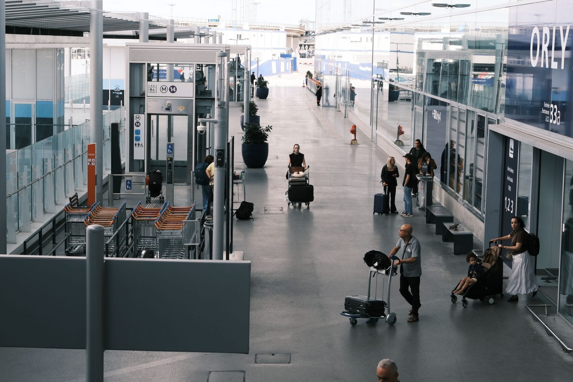 Travellers with luggage carts in an airport terminal, whether flying Jet2.com flight-only or on a Jet2holidays package
