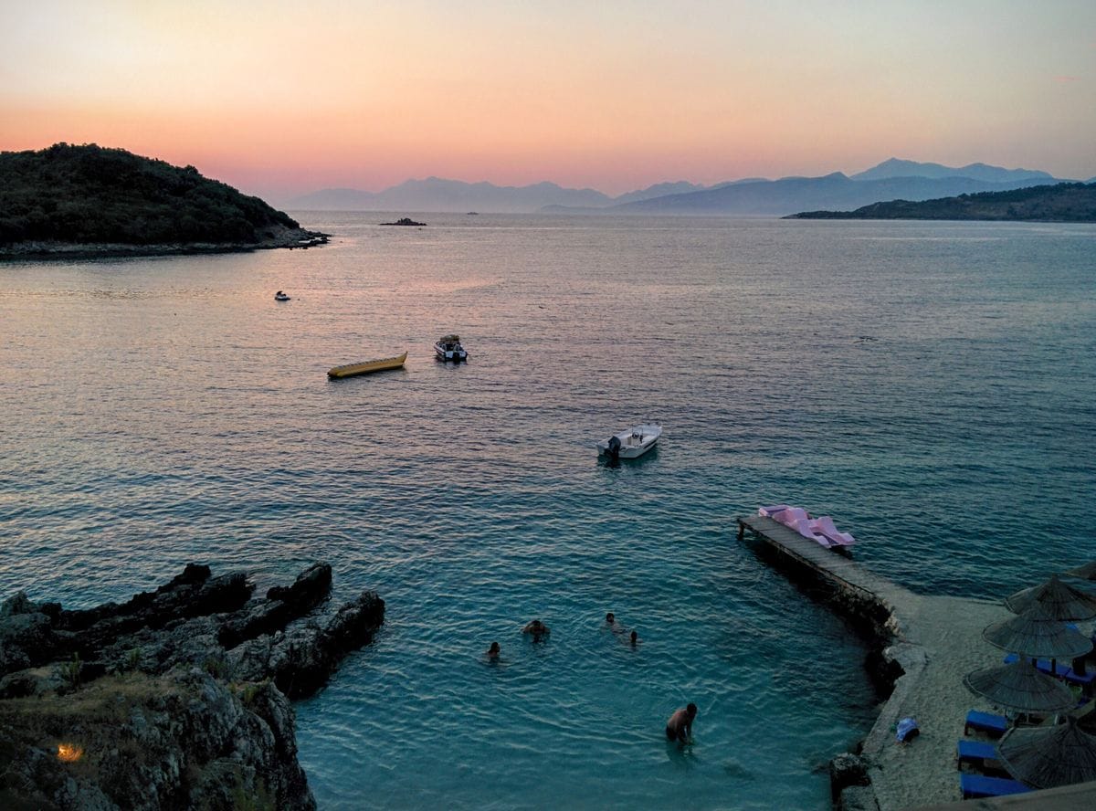 Turquoise water and boats at Ksamil on the Albanian Riviera at sunset