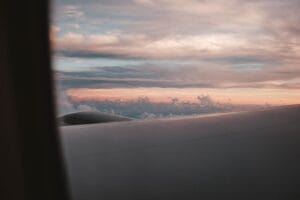 MoneySuperMarket reviews: an airplane wing over sunset clouds