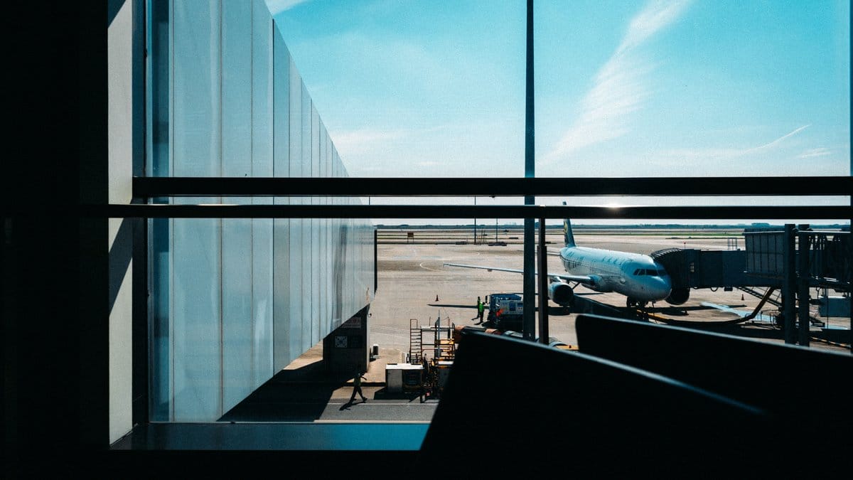 View through an airport terminal window of an aircraft docked at the gate