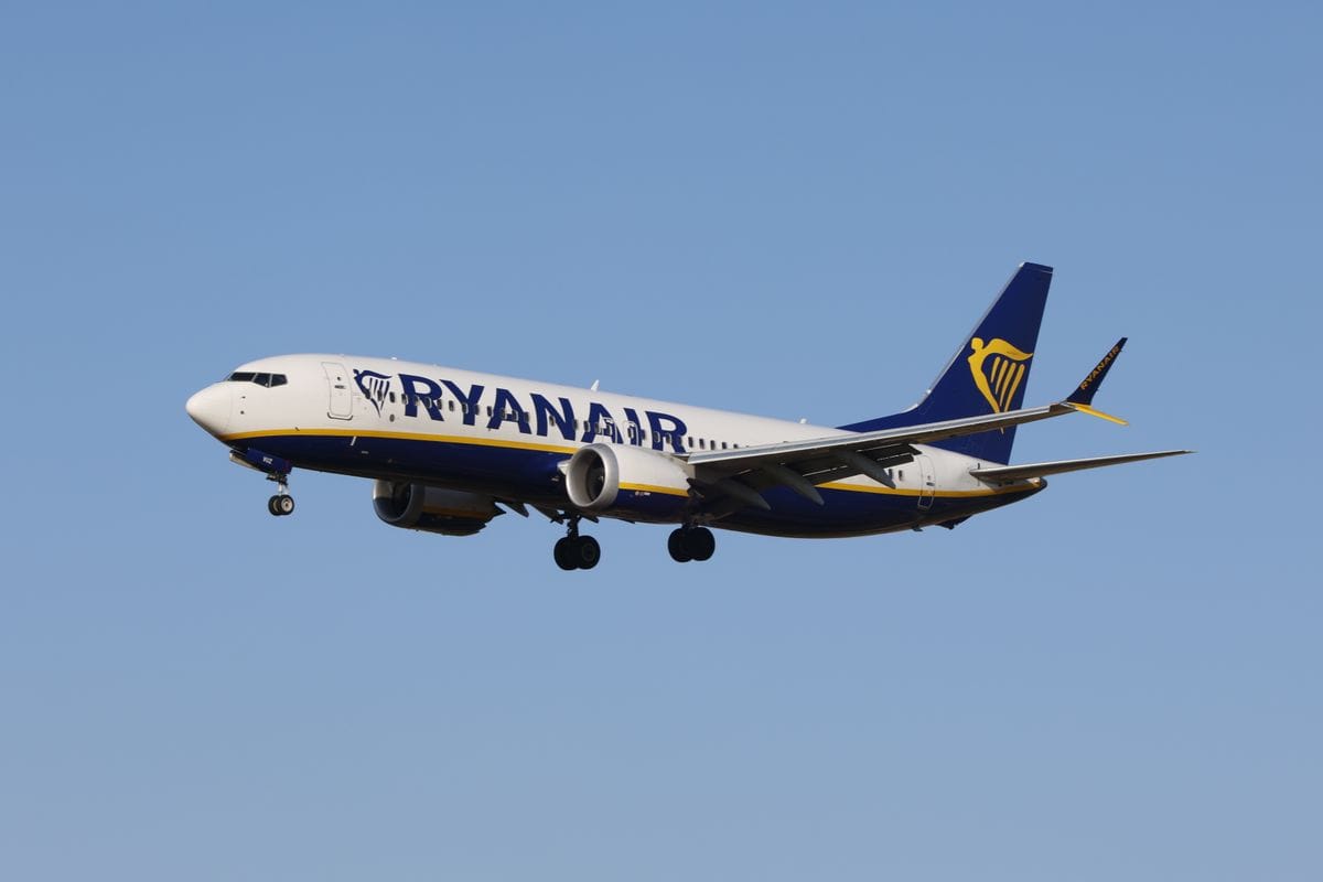 Ryanair Boeing 737 aircraft in flight against a clear blue sky