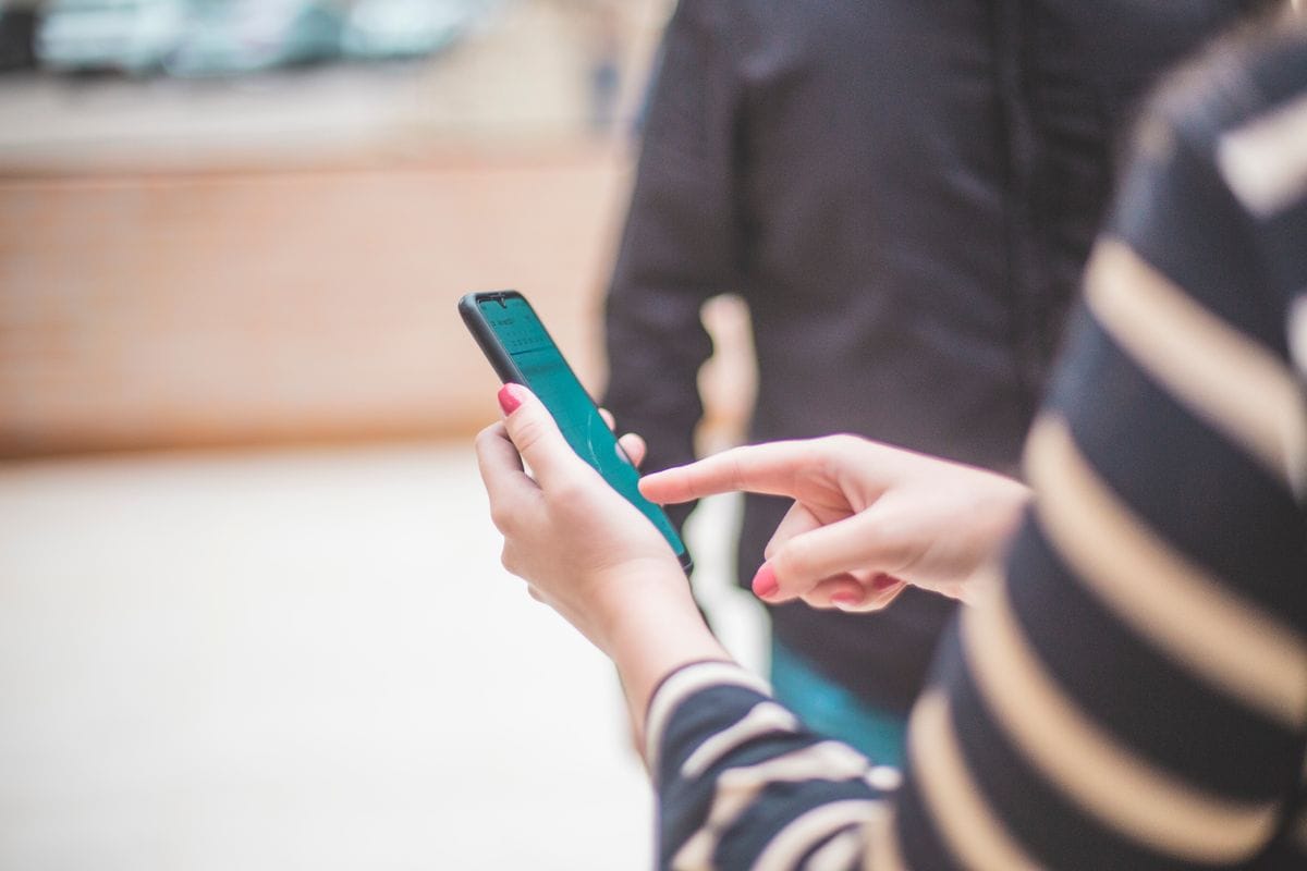Close-up of hands checking a flight sale notification on a smartphone