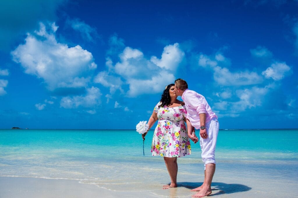 Couple relaxing on a Caribbean beach at Sandals Grande Antigua, Antigua