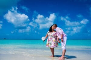 Couple relaxing on a Caribbean beach at Sandals Grande Antigua, Antigua