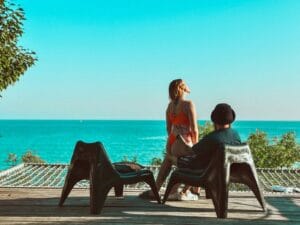 Couple relaxing on a resort terrace overlooking the sea