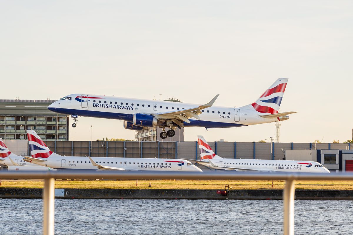 A British Airways jet landing beside the water at London City Airport, which has Club Europe fares in the BA business class sale