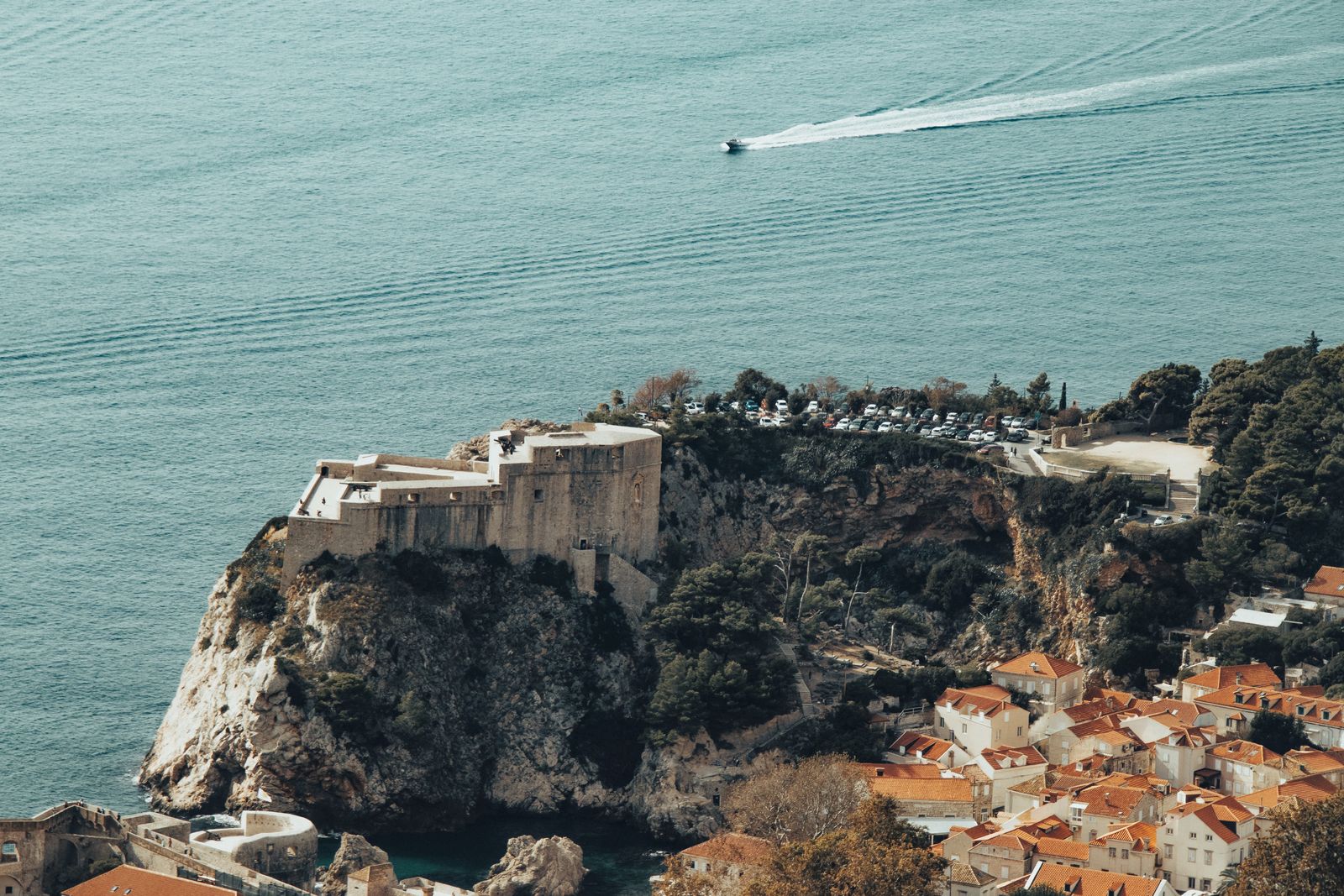 A stone fortress on a rocky headland above the Adriatic near Dubrovnik, with the sea beyond
