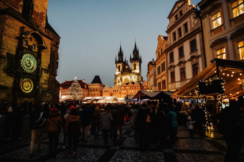 Crowds at the Christmas market in Prague's Old Town Square beside the astronomical clock, an easyJet Christmas markets destination