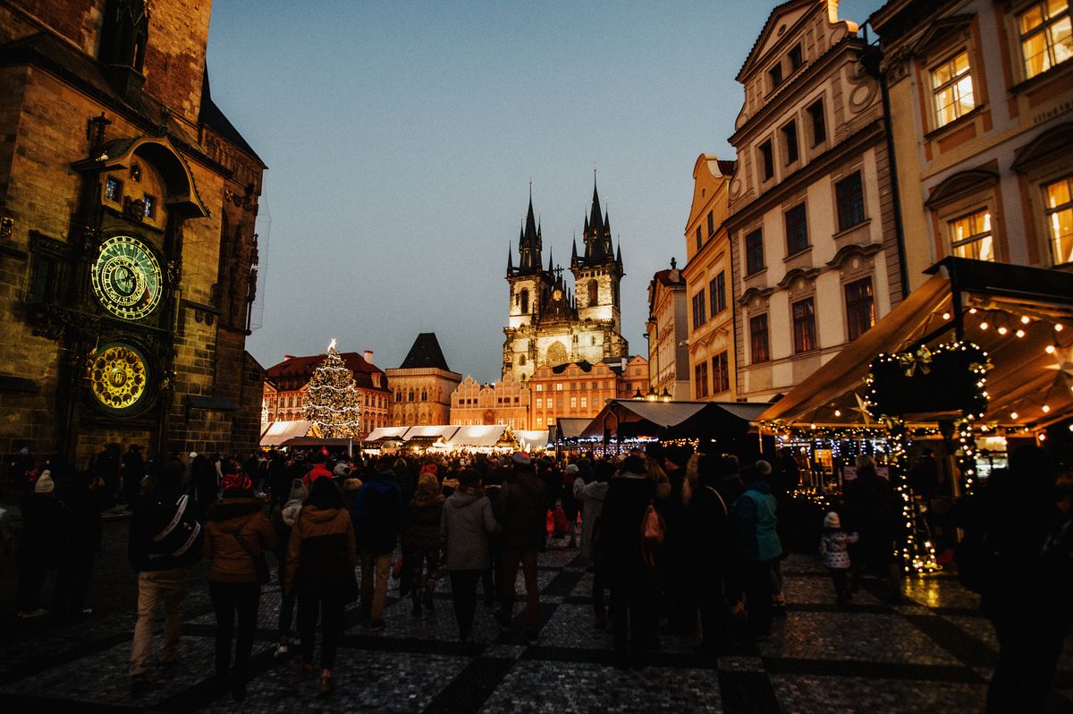 Crowds at the Christmas market in Prague's Old Town Square beside the astronomical clock, an easyJet Christmas markets destination