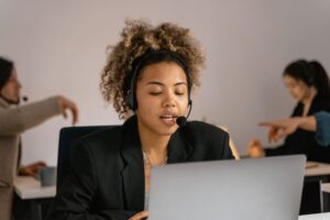 Customer support agent with a headset handling easyJet complaints calls in an office