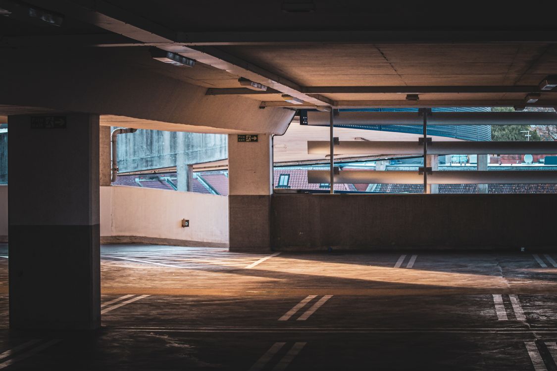 An empty multi-storey car park with sunlight across the bays, like the Short Stay car parks at Gatwick Airport terminals