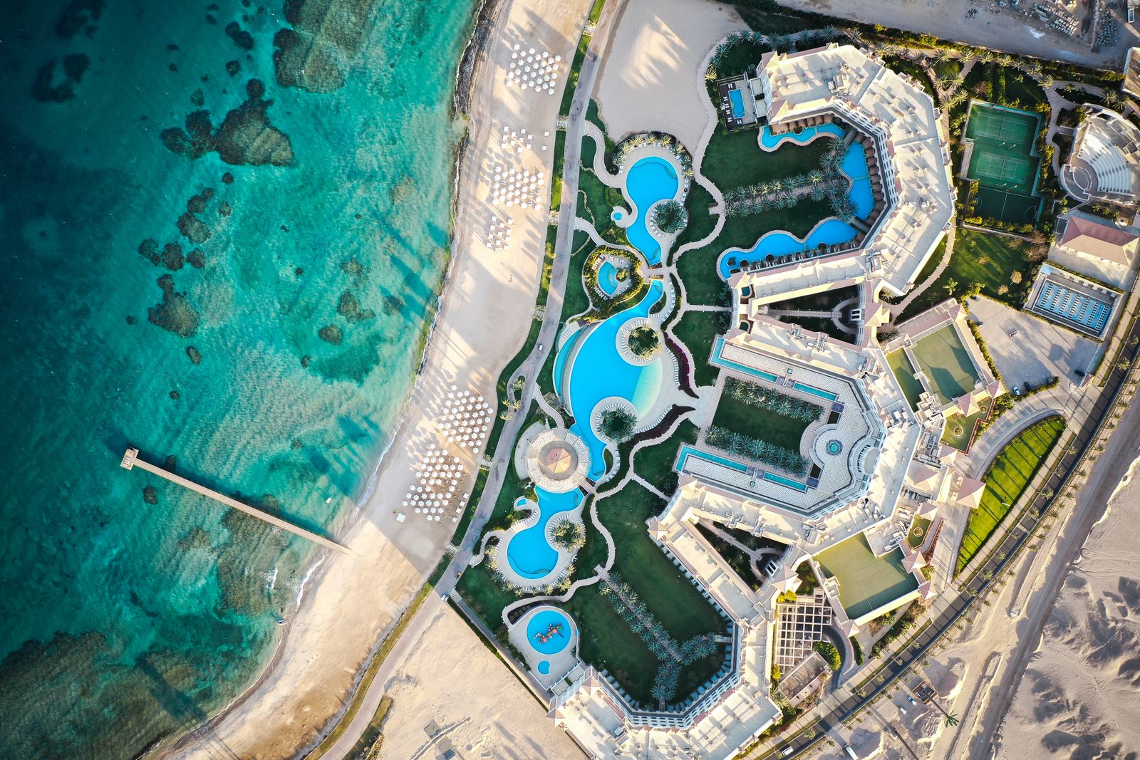A beachfront resort and its pools on the Red Sea coast at Hurghada, seen from above