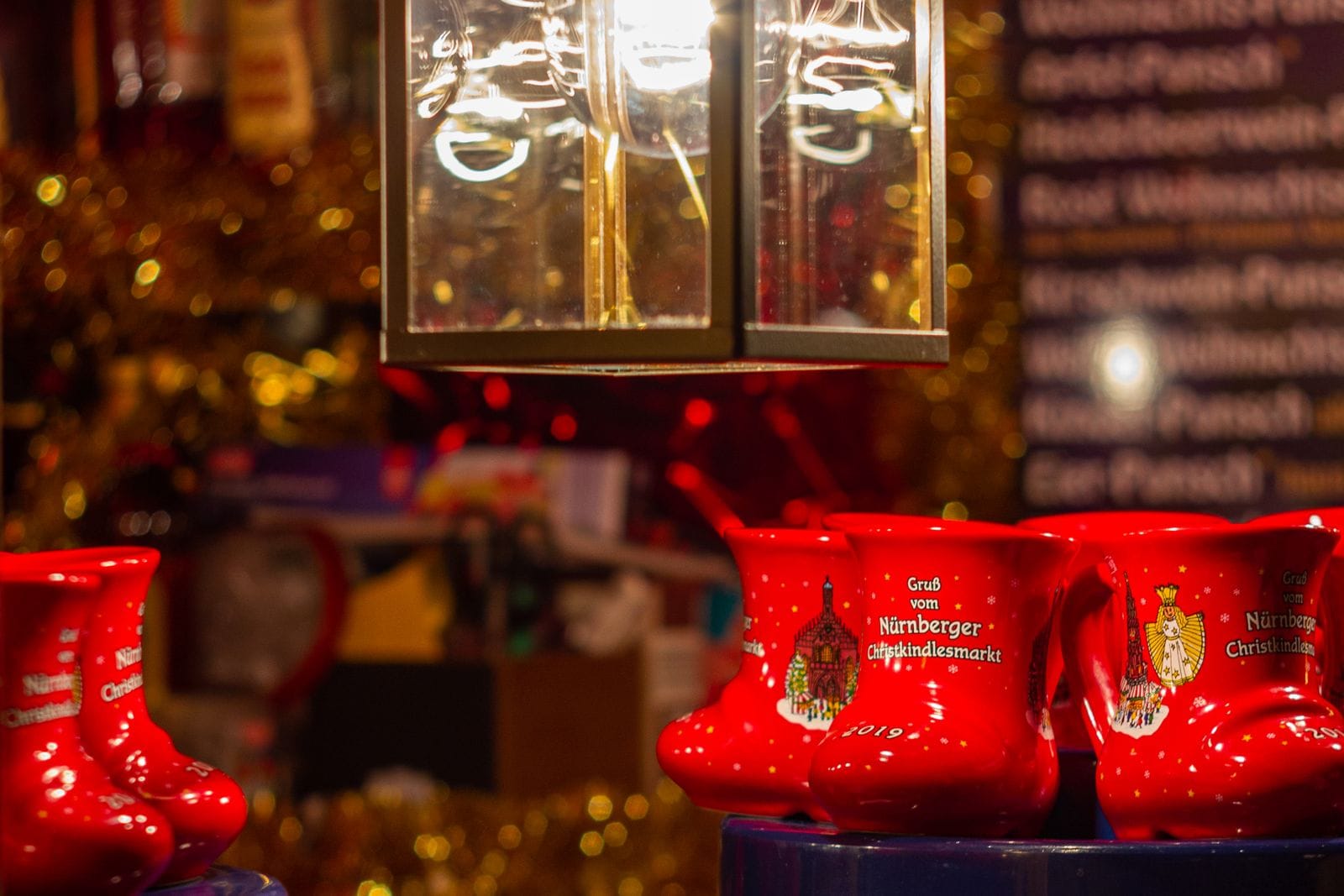 Red boot-shaped souvenir mugs for mulled wine on a stall at the Nuremberg Christkindlesmarkt